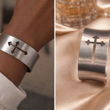 Brushed stainless steel cuff bracelet with cutout cross design worn on wrist