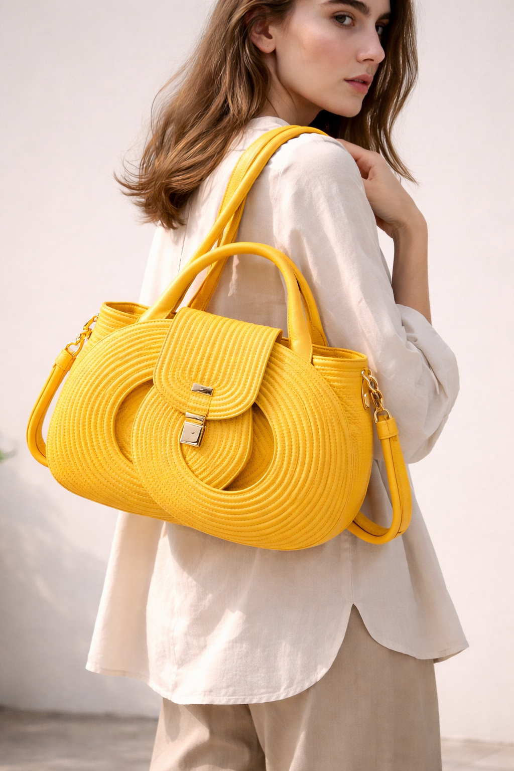 Yellow infinity handbag worn on shoulder, handwoven cotton cord structured bag with double handles and detachable strap