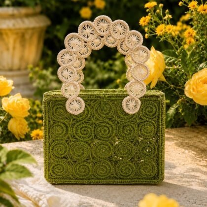 Loden Green Handbag with cream double handles Collected Abroad Loden Green woven structured handbag Green statement handbag with circular woven detailing Compact woven loden green handbag for boutique styling Sculptural green handbag with contrast cream handles