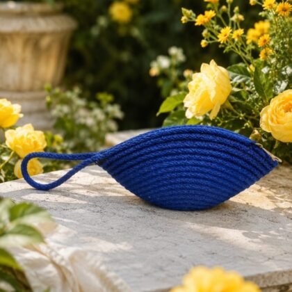 Royal Blue Macramé Wristlet from the Infinity Collection styled on model Woven royal blue wristlet with braided loop detail Compact royal blue macramé clutch with zip closure Infinity Collection woven wristlet in rich royal blue
