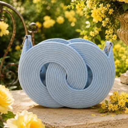 Infinity Handbag Collection sky blue woven macramé crossbody shoulder bag Sculptural sky blue woven handbag with circular design Blue macramé handbag with adjustable removable strap Boutique sky blue statement handbag with lined interior