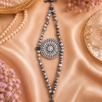 Vintage-inspired gray pearl and crystal medallion bracelet Silver-tone statement bracelet with rhinestone medallion centerpiece Gray pearl-style bracelet with crystal accents and toggle clasp Elegant vintage-style bracelet with sparkling medallion Boutique statement bracelet with pearl and crystal details