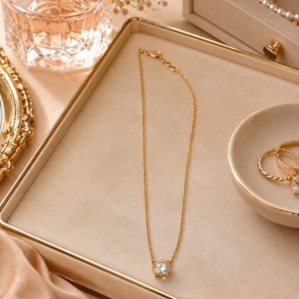 Kate Spade gold-tone crystal pendant necklace with clear crystal drop on delicate 18-inch chain.