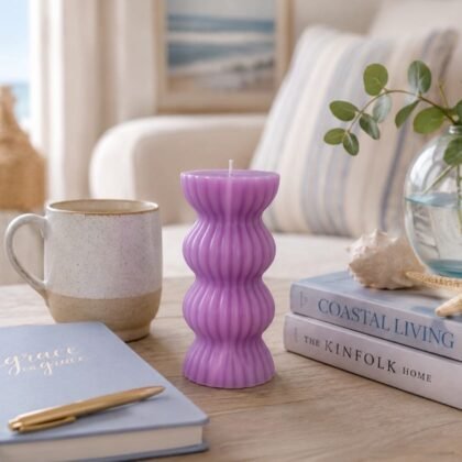 Lavender sculptural ribbed candle displayed as a decorative home accent on a styled tabletop setting.