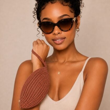 Tory Burch brown tortoise cat-eye sunglasses with tan case in lifestyle setting Designer sunglasses with brown gradient lenses and gold-tone hardware Tory Burch sunglasses styled in sunlit outdoor scene Close-up of brown tortoise frame cat-eye sunglasses Luxury sunglasses with coordinating tan protective case