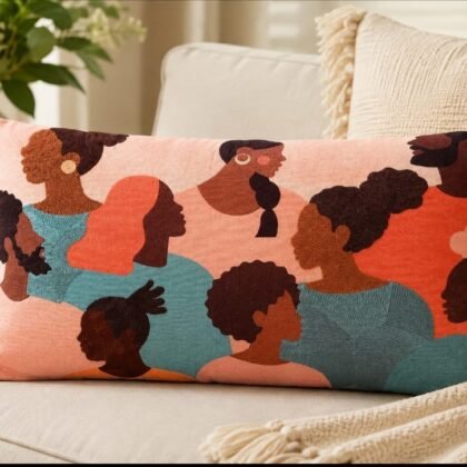 THRO Home 14 × 24 decorative pillow featuring colourful artistic portraits of women in coral, teal, blush, brown, and black.